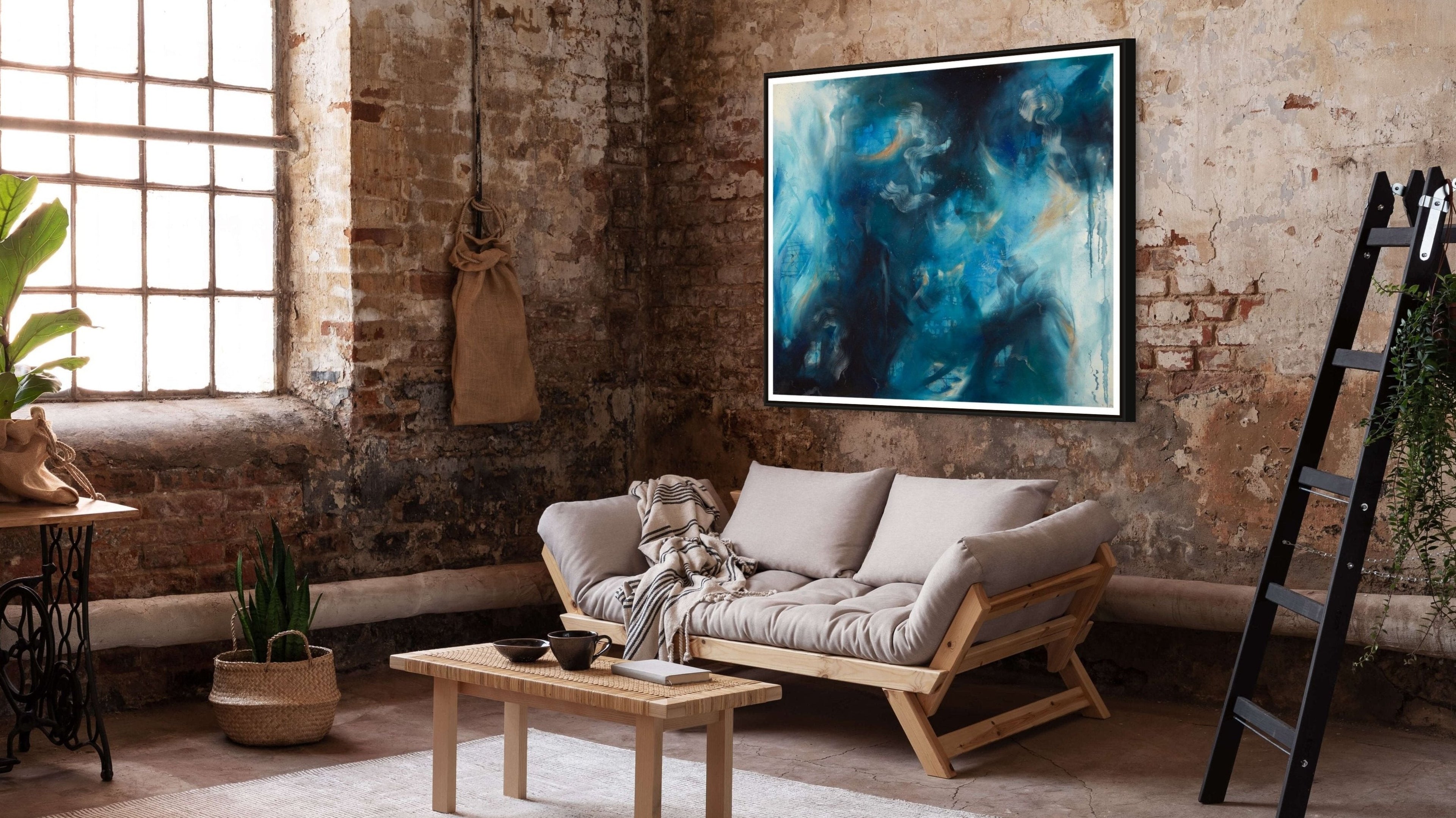 Sapphire Iris abstract art print hanging on a rustic brick wall, enhancing the space with bold blue and black tones.